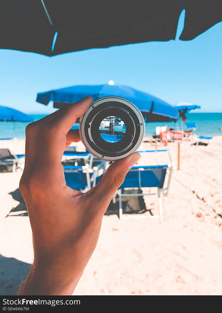 Person Holding Gray Lens