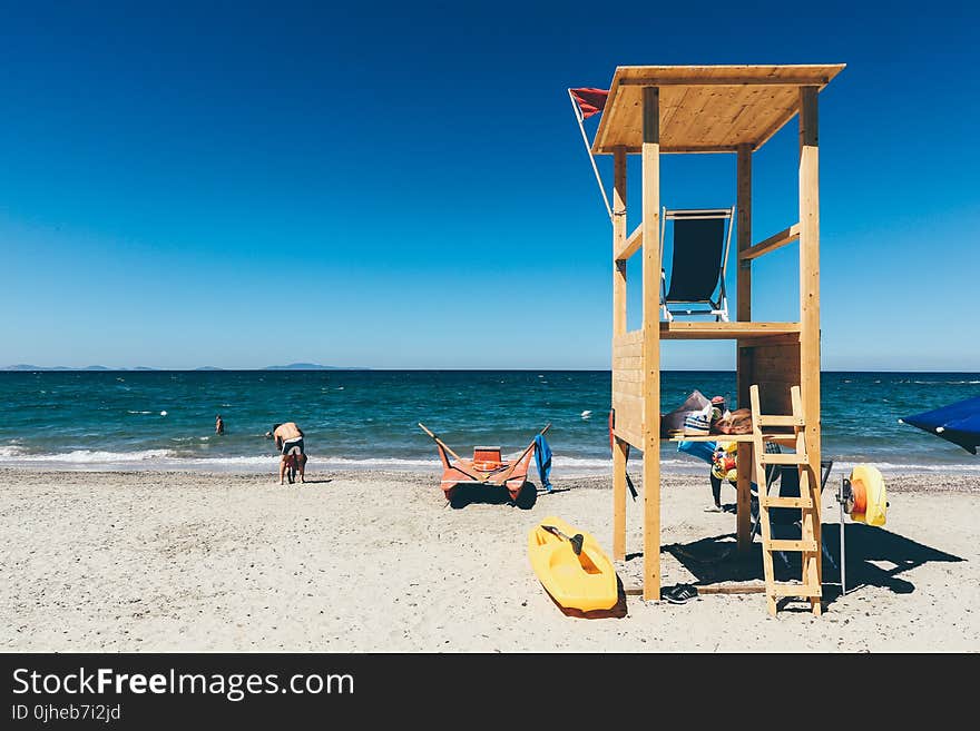 Beige Wooden Watch House Near Ocean