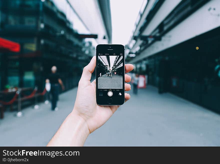 Person Holding Space Gray Iphone 5s