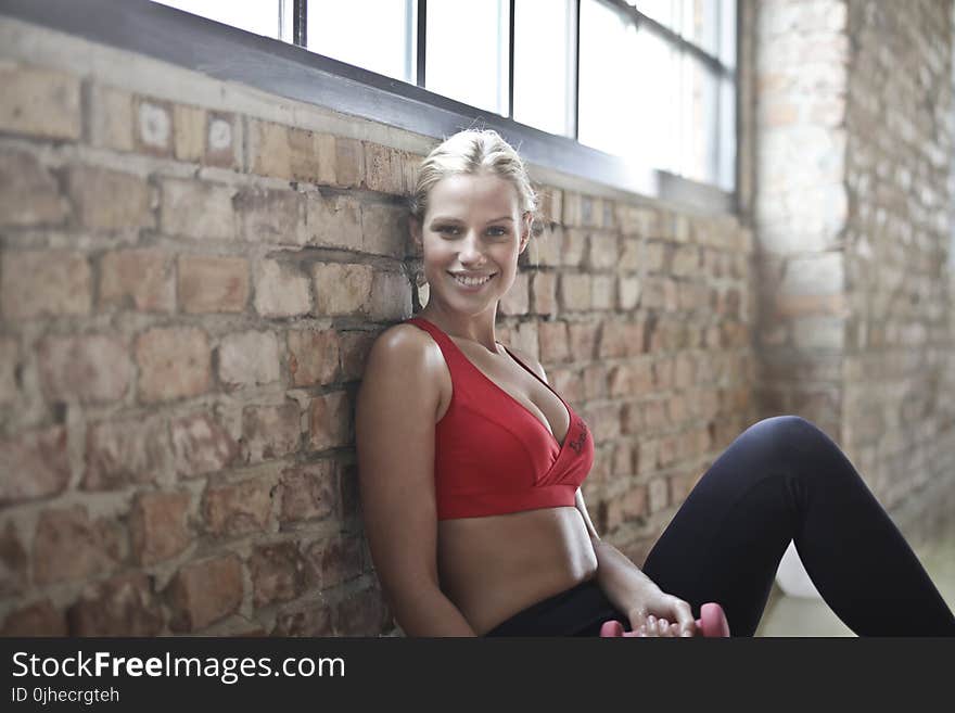 Woman Wearing Red Sports Bra and Black Pants