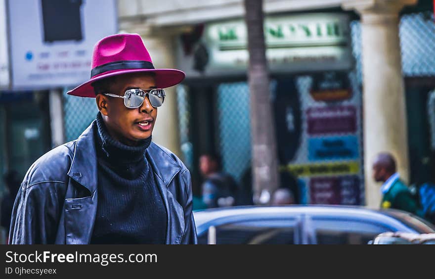 Man Wearing Purple Hat and Black Leather Jacket