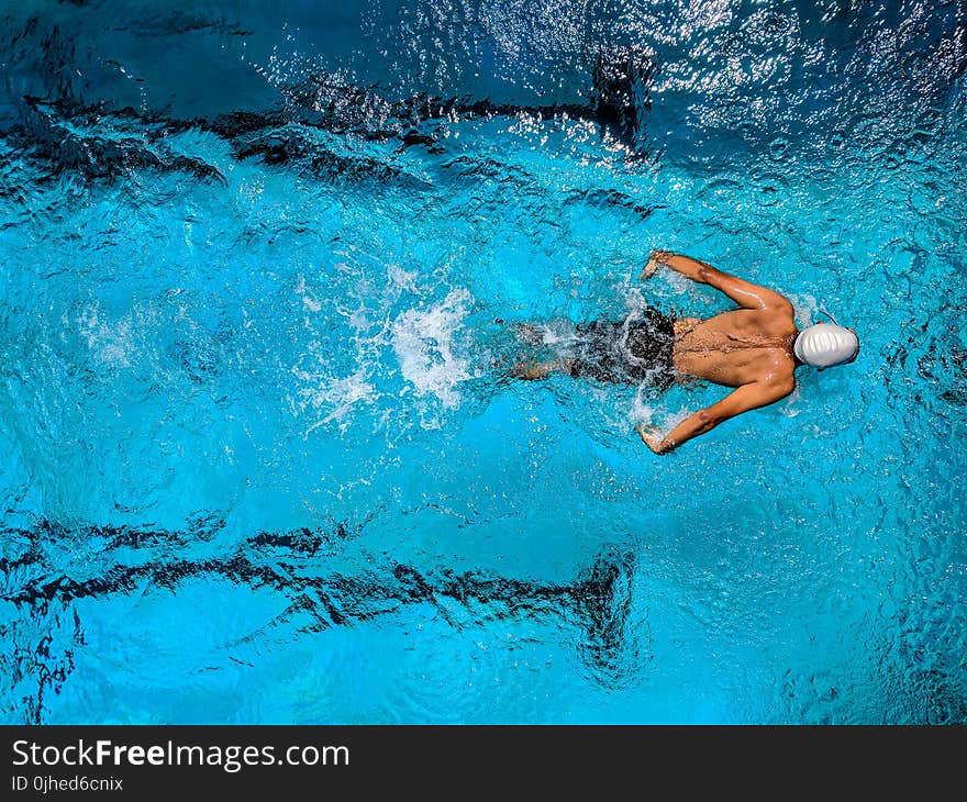 Person Swimming on Body of Water