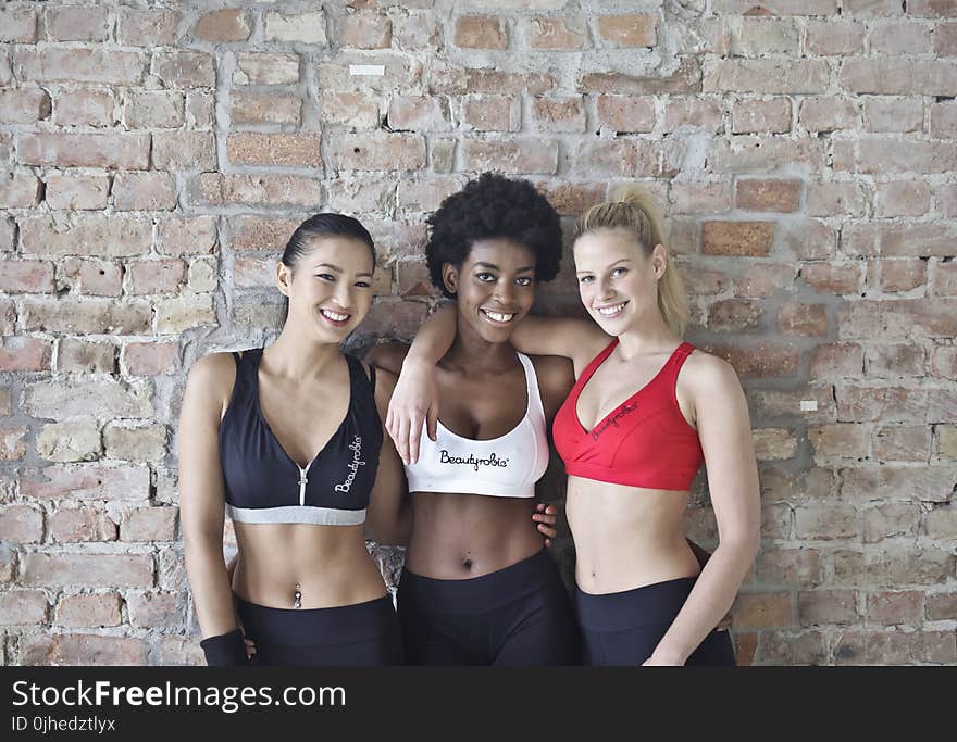 Three Women Wearing Sports Bras and Leggings