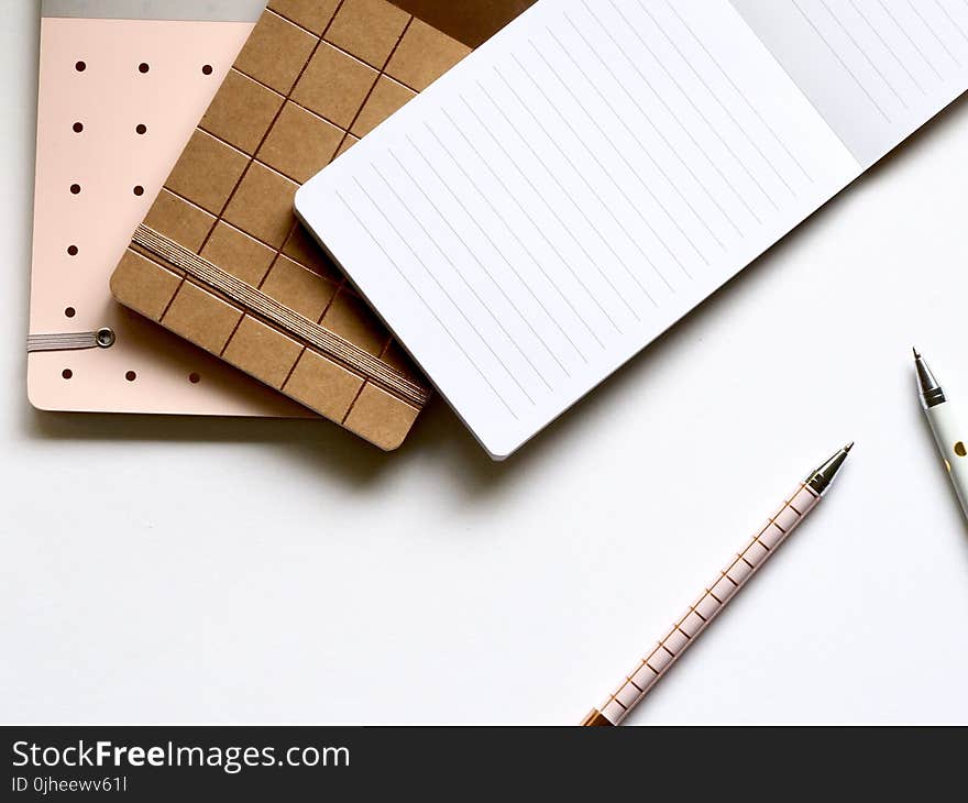 Pad With Pens on Table