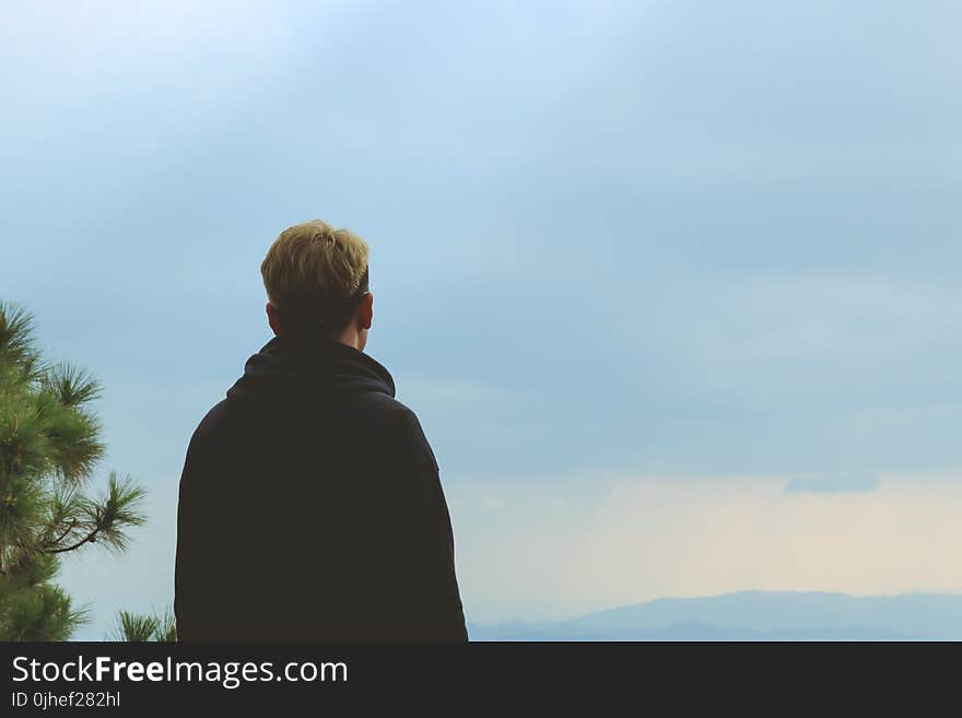 Man Wearing Black Jacket Standing Near Tree