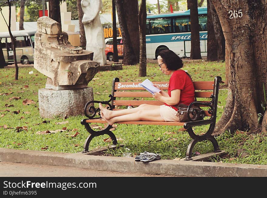 Woman In Red Shirt Sitting On Bench