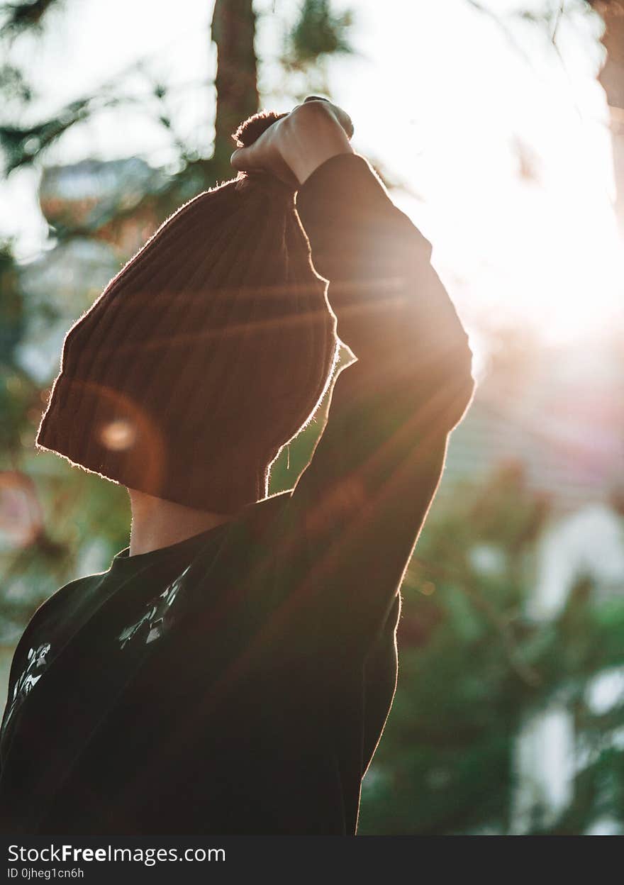 Person Covering Its Face With Knitted Hat