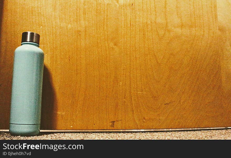 Blue and Silver Tumbler on Top of White Floor