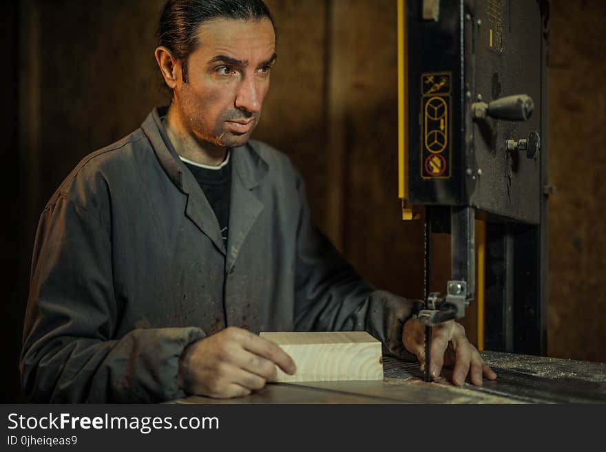 Man in Gray Dress Shirt Operating Band Saw