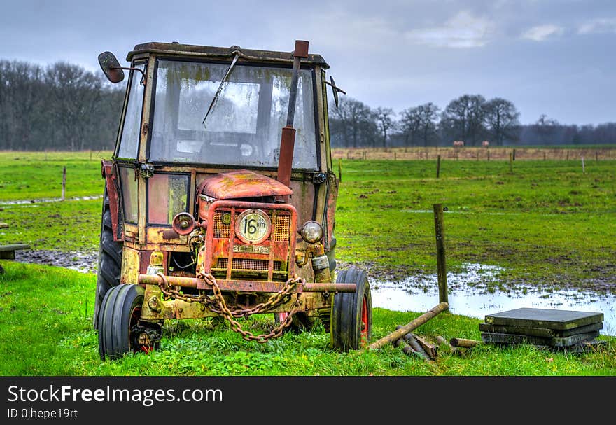 Yellow Farm Equipment on Green Grass Field