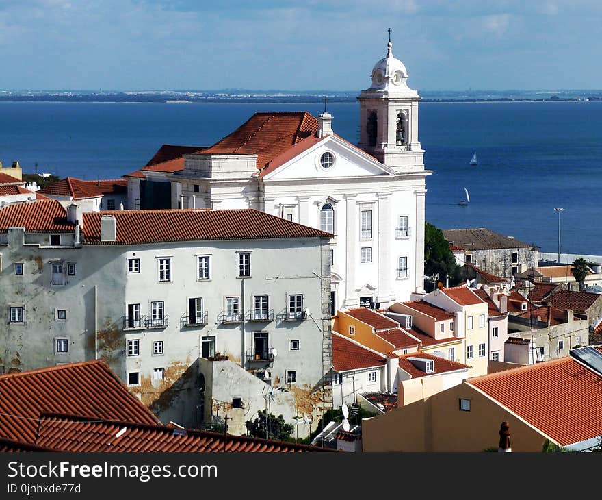 White Church and Brown Roofs with Blue Background