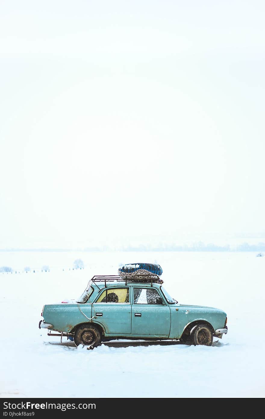 Blue Sedan on Snow