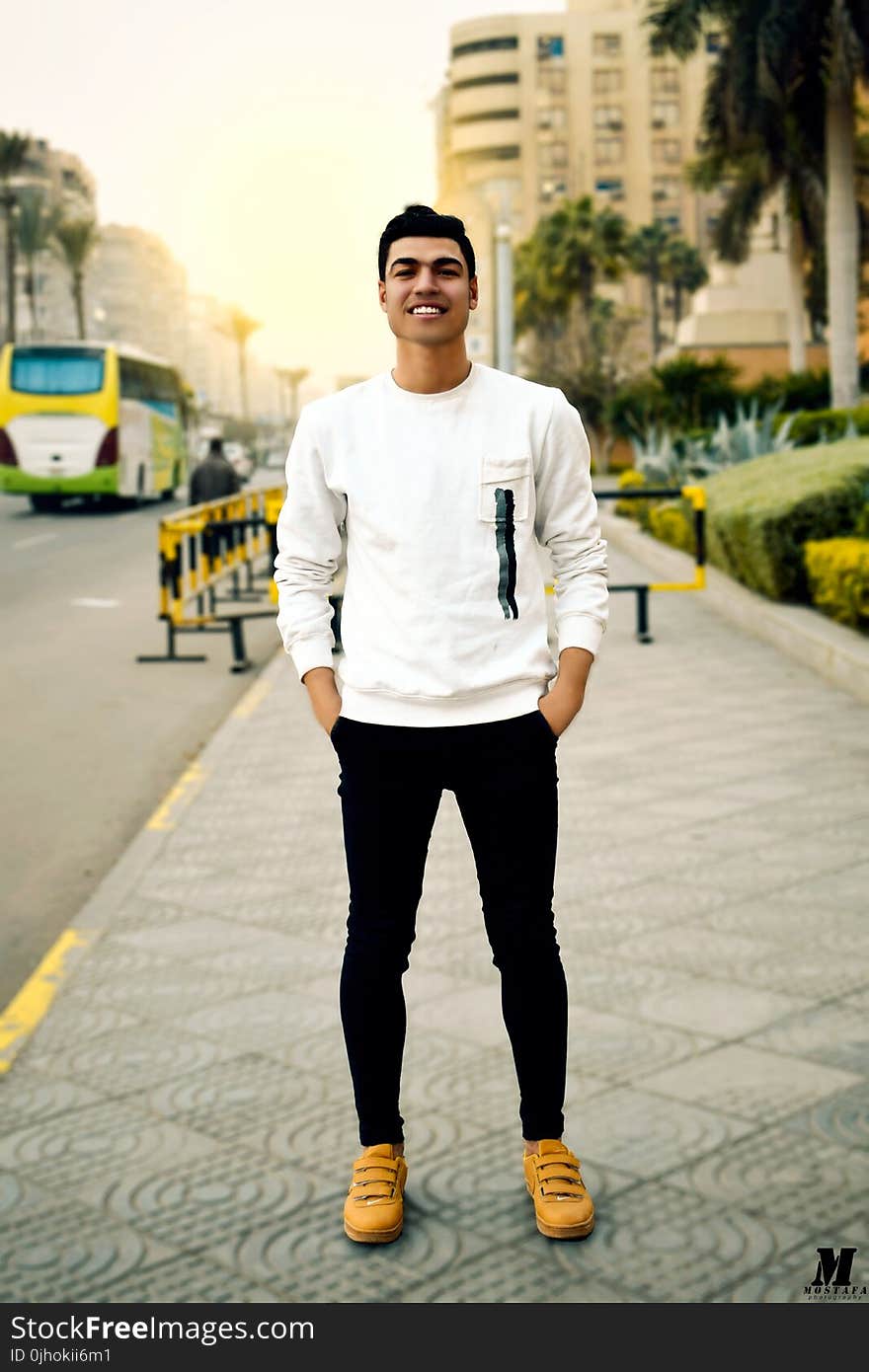 Man in White Crew-neck Sweater Taking Selfie Beside Street Road