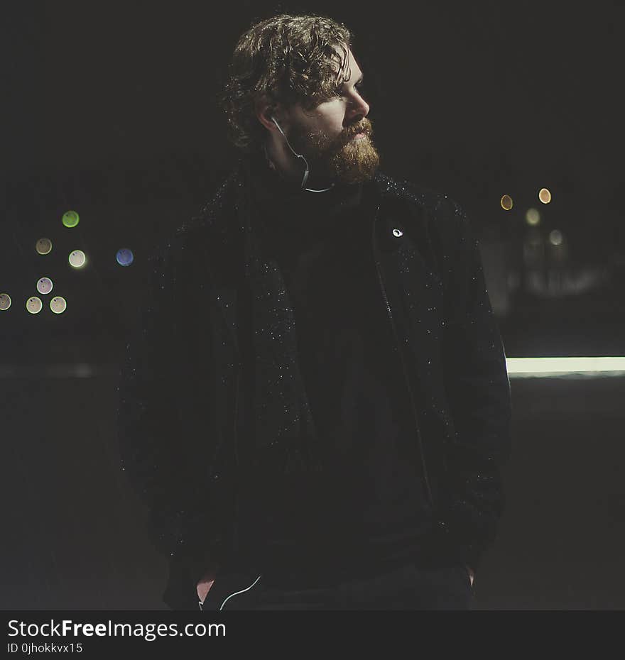 Man Wearing Black Zip-up Jacket Taking Picture during Nighttime