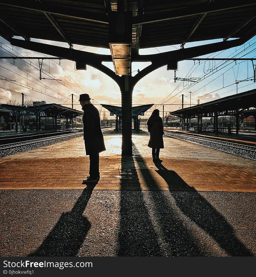 Man and Woman Silhouette Standing on Brown Ground at Daytime