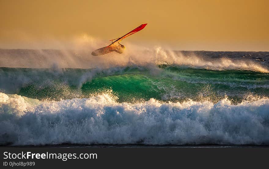 Person Ridding Wind Boat Above Ocean Wave