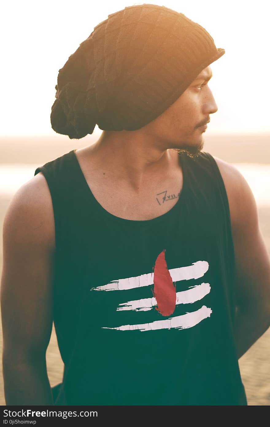 Man Wears Black and White Tank Top and Black Knit Cap