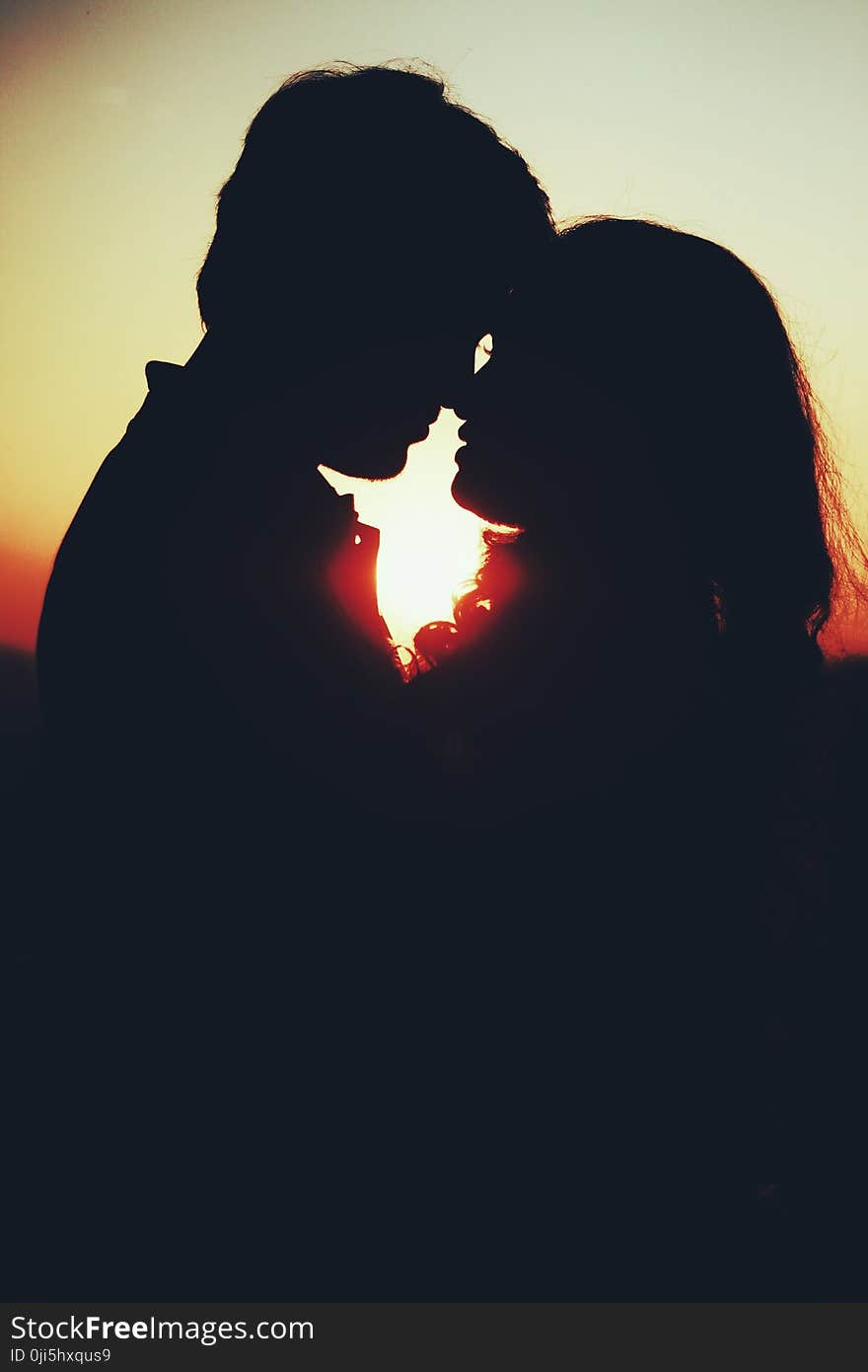 Silhouette Photo of Man and Woman About to Kiss