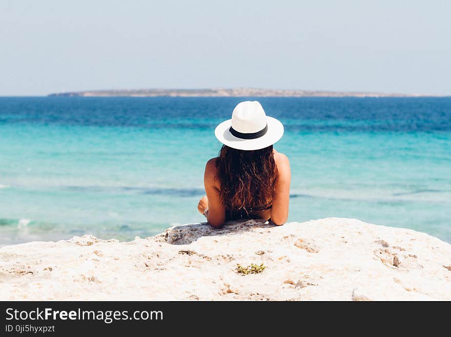 Woman Lying on White Sand Beach