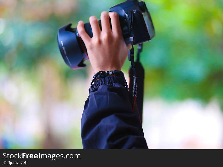 Person Holding Black Dslr Camera