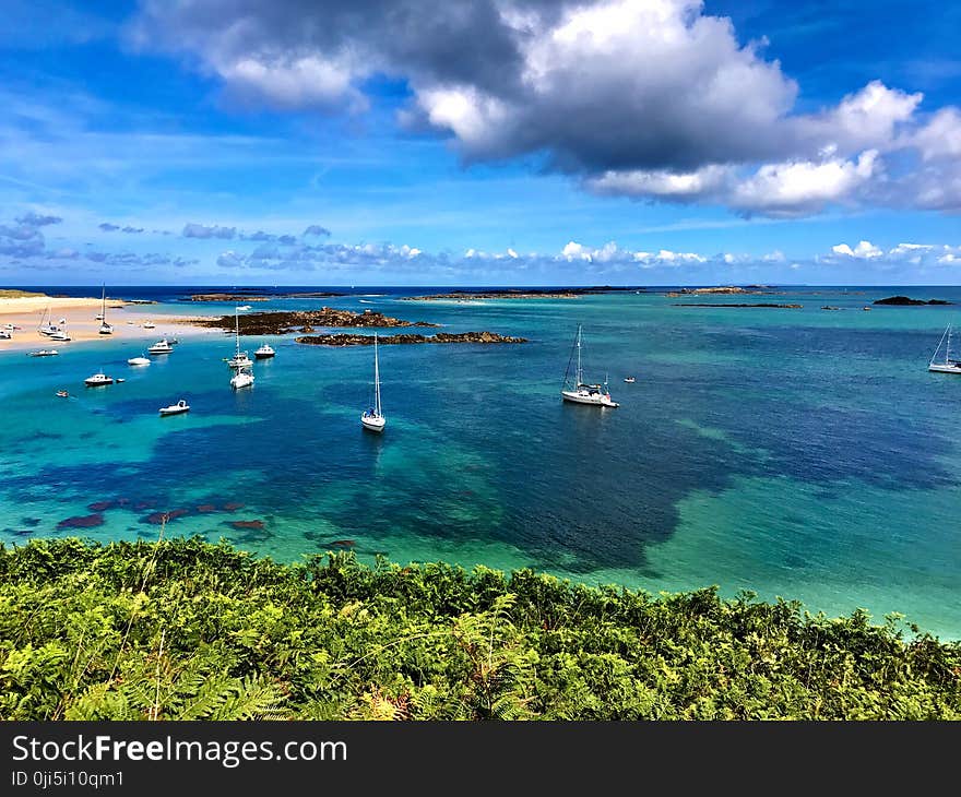 High Angle Photography of Beach With Sailing Boats Under Blue Sky and Gray Clouds