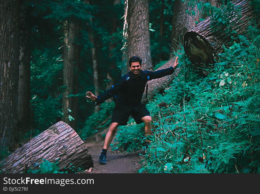 Man Wearing Black Jacket Standing on Forest