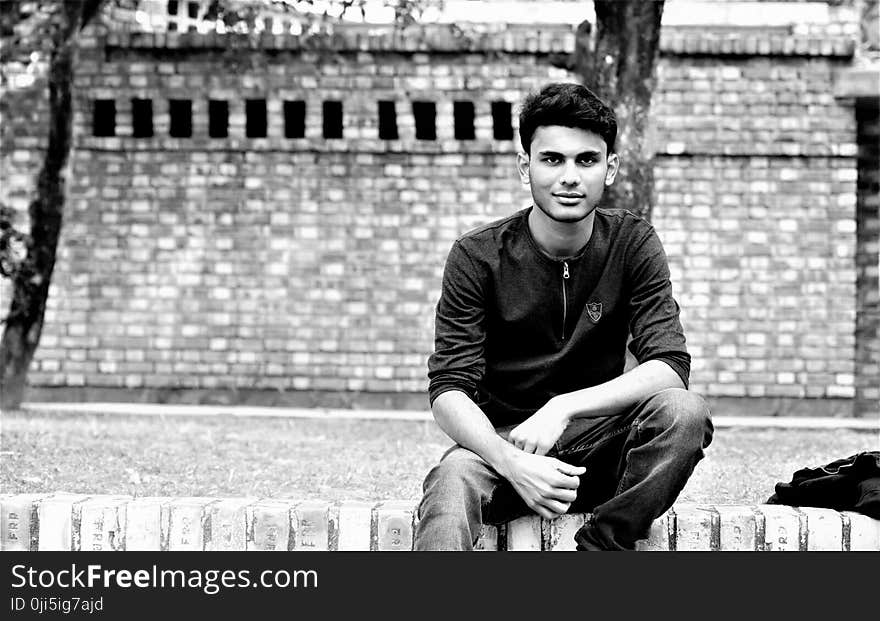 Grayscale Photography of Man in Front of Wall