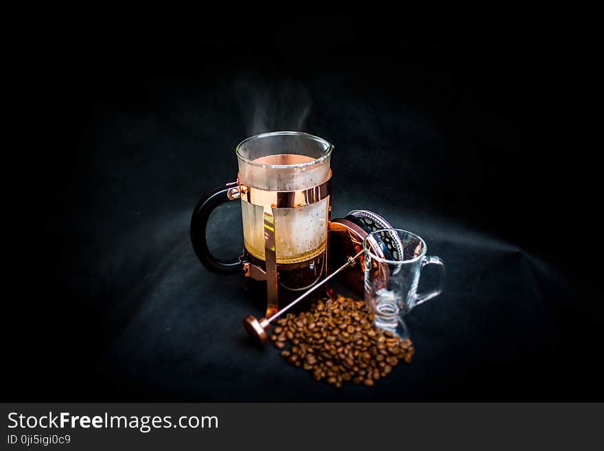 Photo of Open Coffee Press Beside Glass