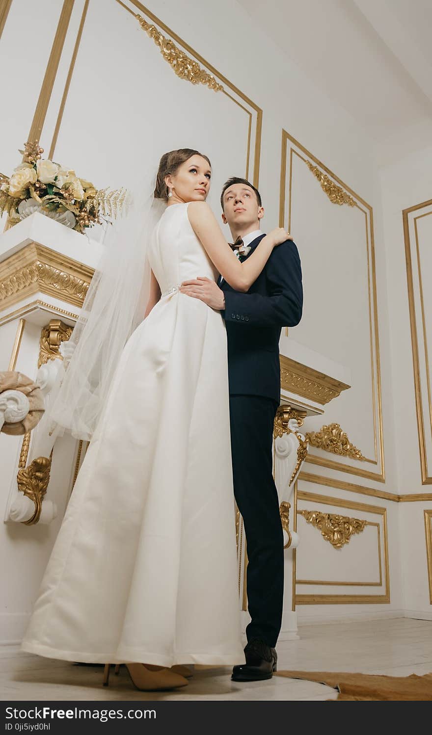 Woman Wearing White Sleeveless Bridal Gown Holding Man