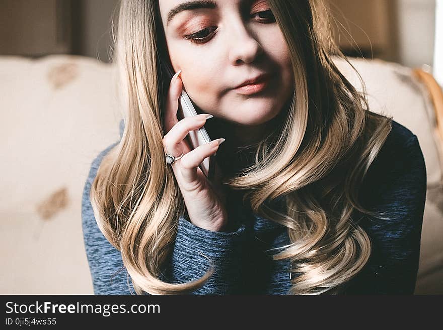 Woman in Gray Top Using Her Mobile Phone