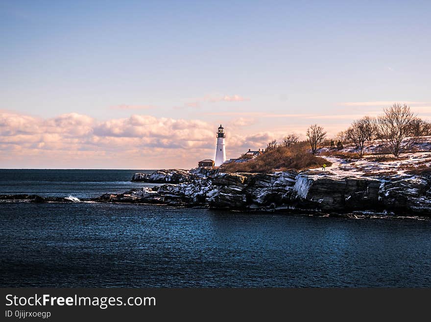 White Lighthouse during Cloudy Day