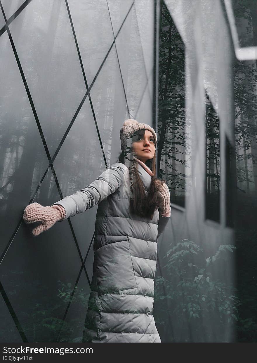 Woman Wearing White Bubble Jacket, Knitted Hat and Gloves