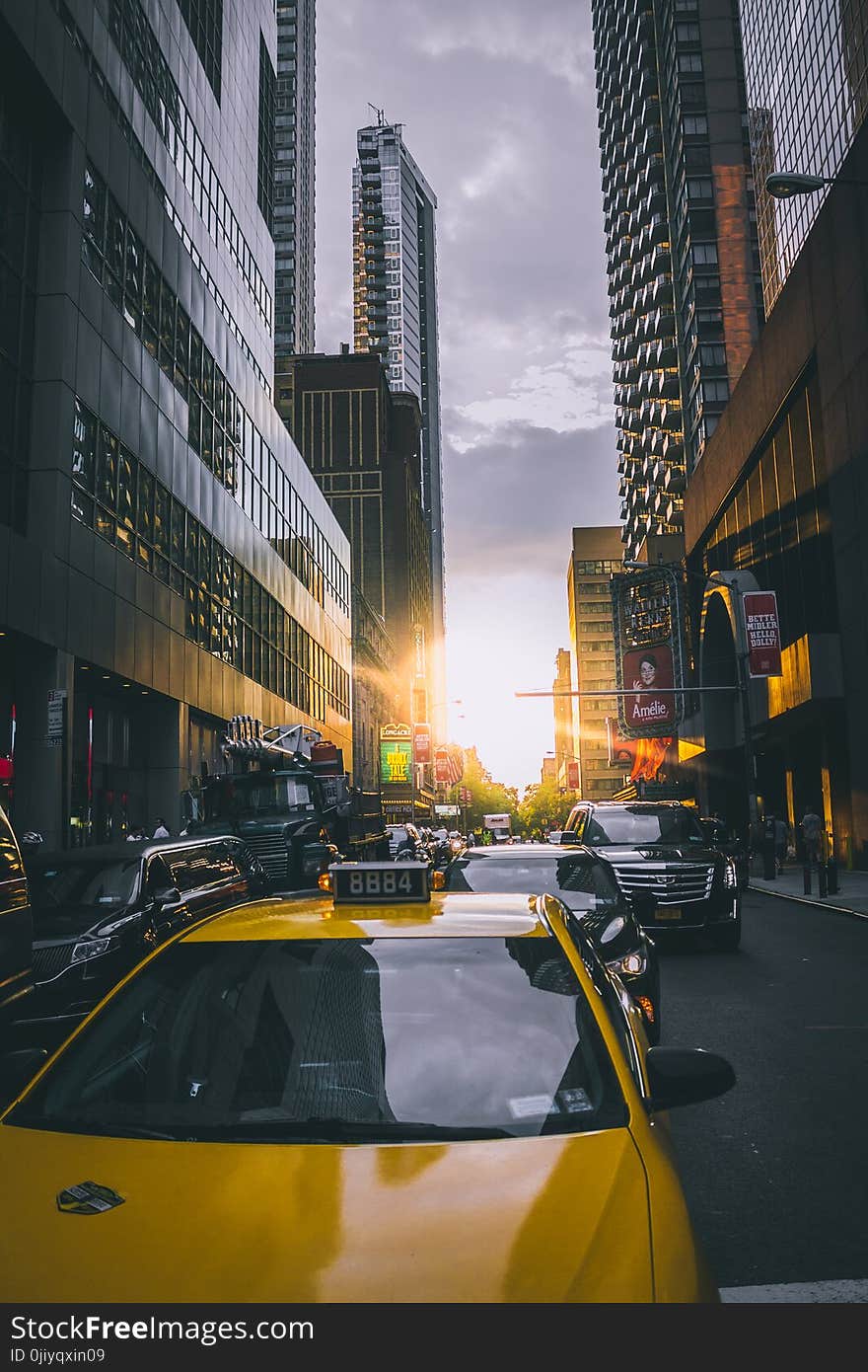 Photo of Cars on Asphalt Road Near Buildings