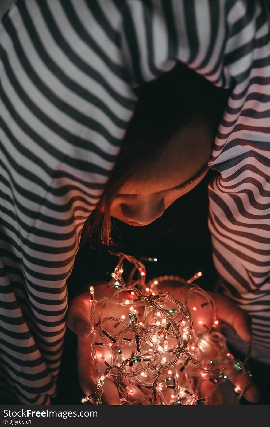 Woman Holding White String Lights