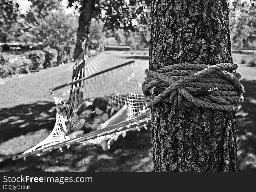 Girl and Boy on Hammock Grayscale Photo