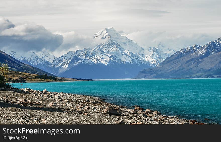 Body of Water Surrounded by Mountain