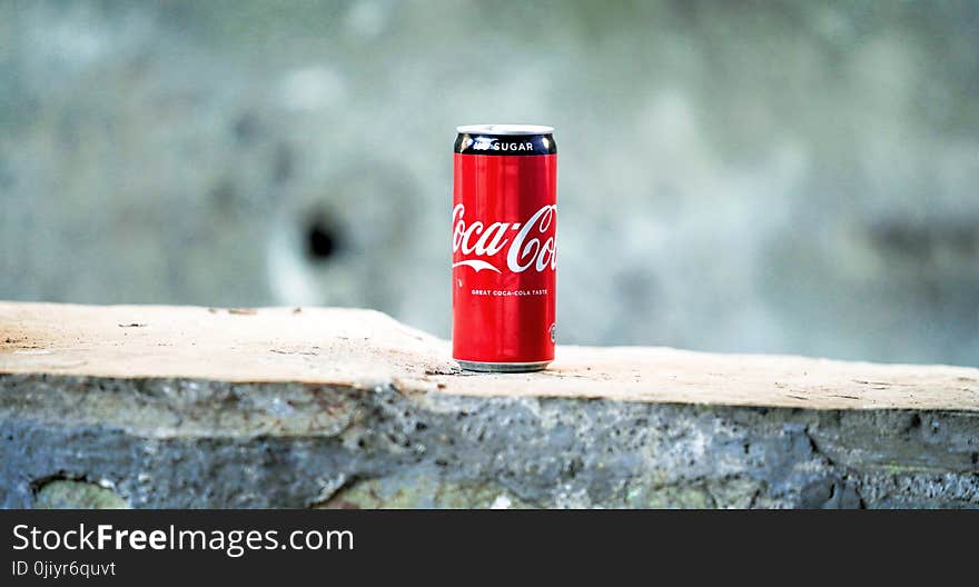 Coca-cola Can on Brown Concrete Surface