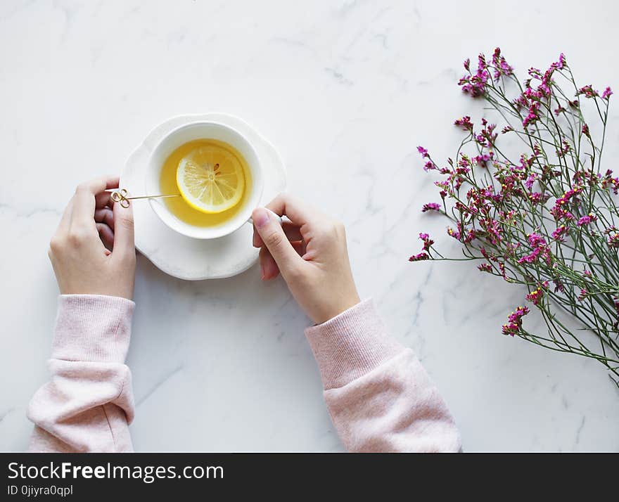 Lemonade Juice Filled White Ceramic Cup With Saucer