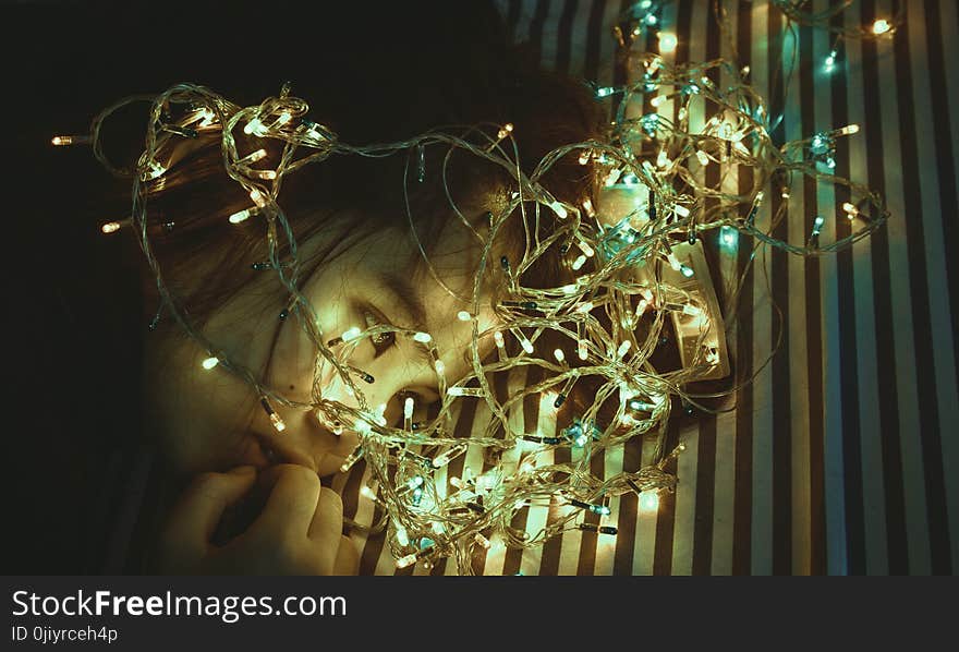 Woman Near Assorted-color String Lights