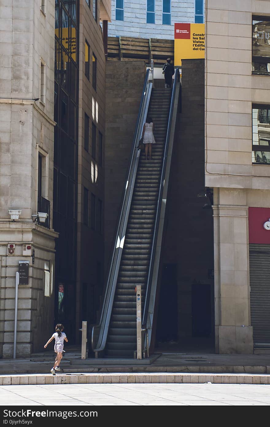 Girl Walking Towards the Escalator