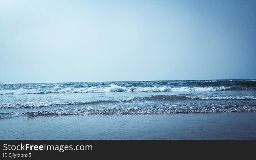 Calm Water on Seashore at Daytime