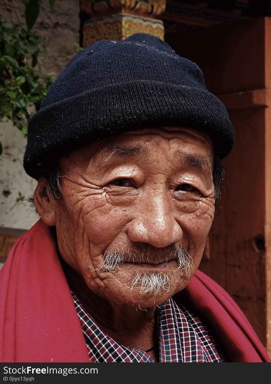 Smiling Man Wearing Red Scarf and Black Beanie