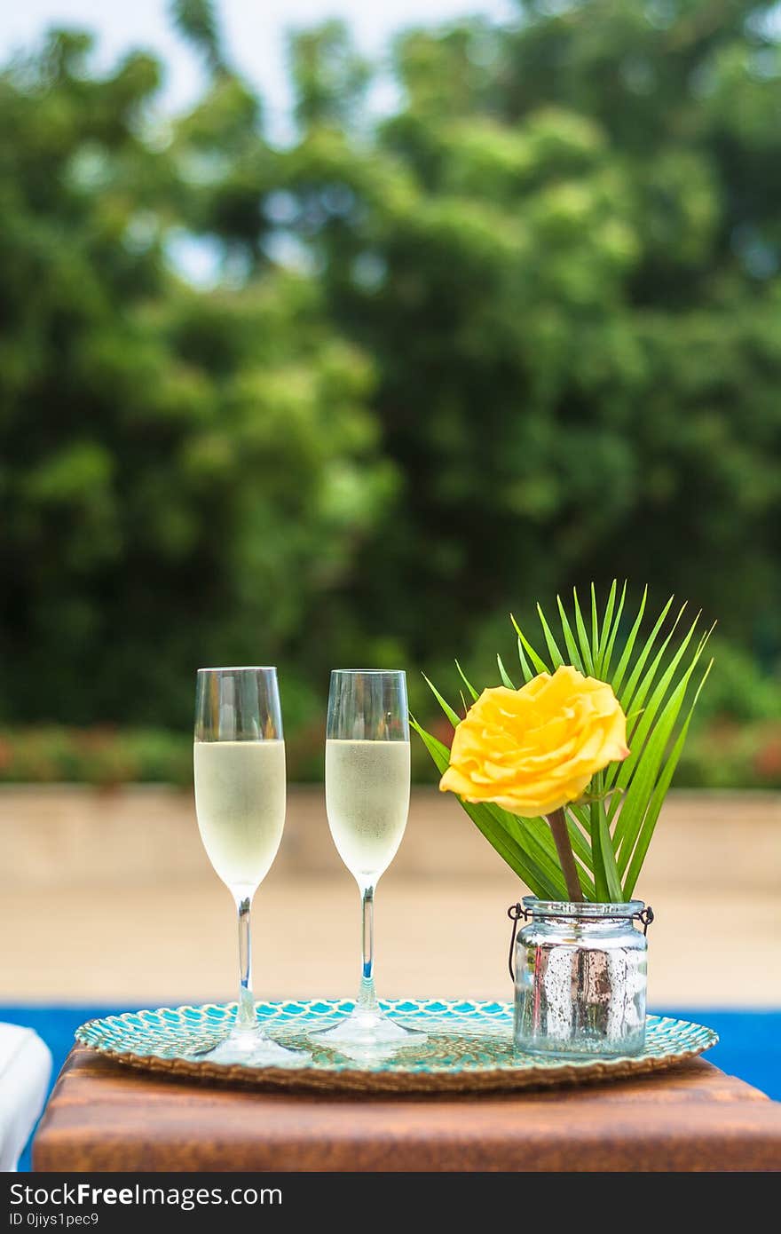 Yellow Rose Flower Centerpiece and Two Clear Champagne Flutes