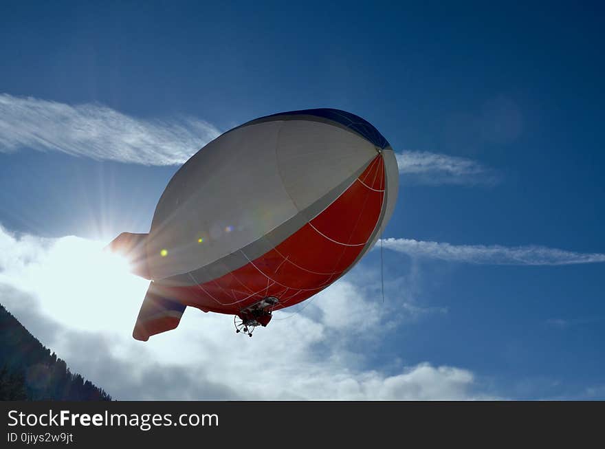 White and Red Blimp Flying