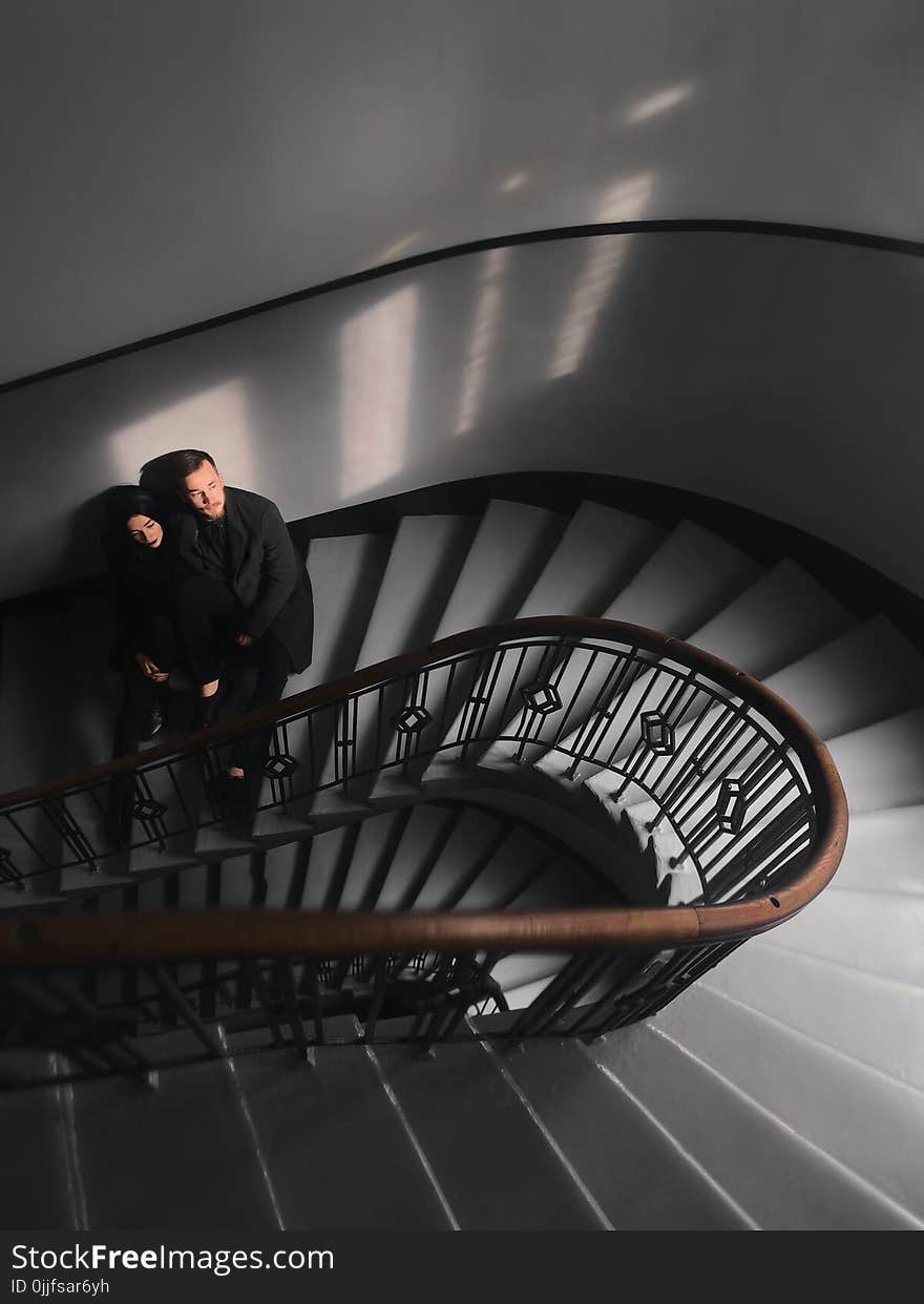 Woman and Man Standing on Stairs