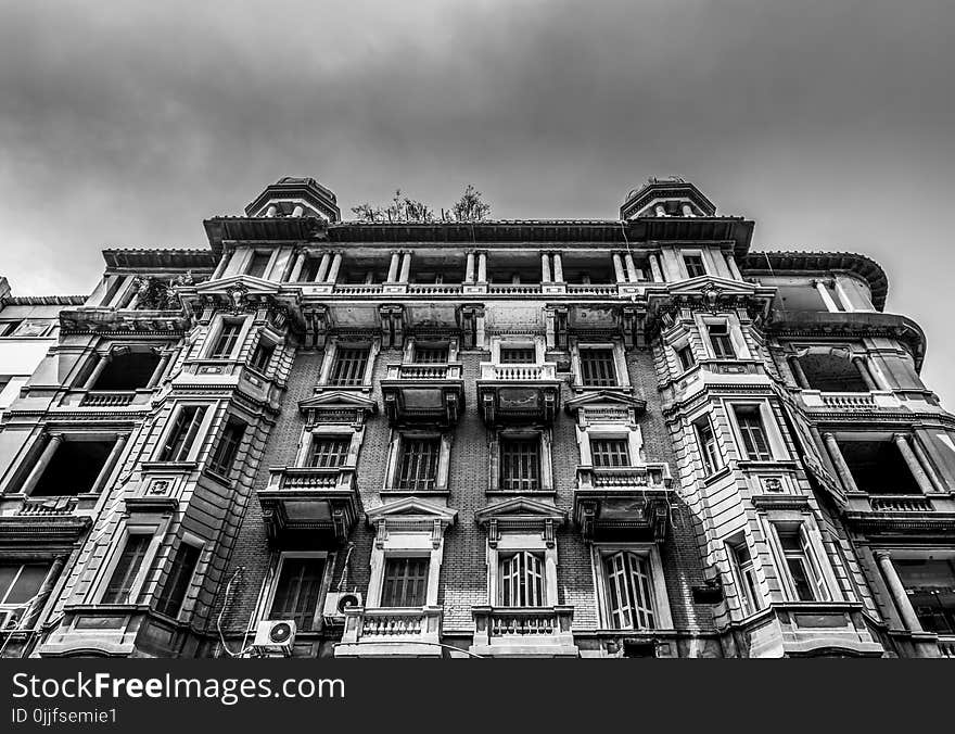 Low-angle and Grayscale Photo of Concrete Building