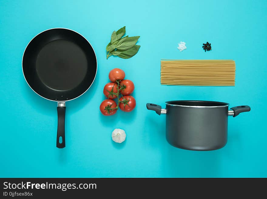 Black and Gray Cooking Pot and Frying Pan With Tomatoes