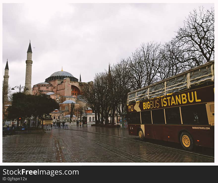 Brown Bigbus Istanbul Traveling on Road Near Brown Dome Building