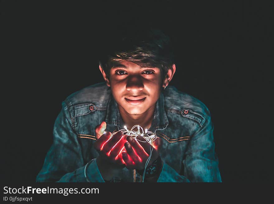 Man Holding White String Light Photo