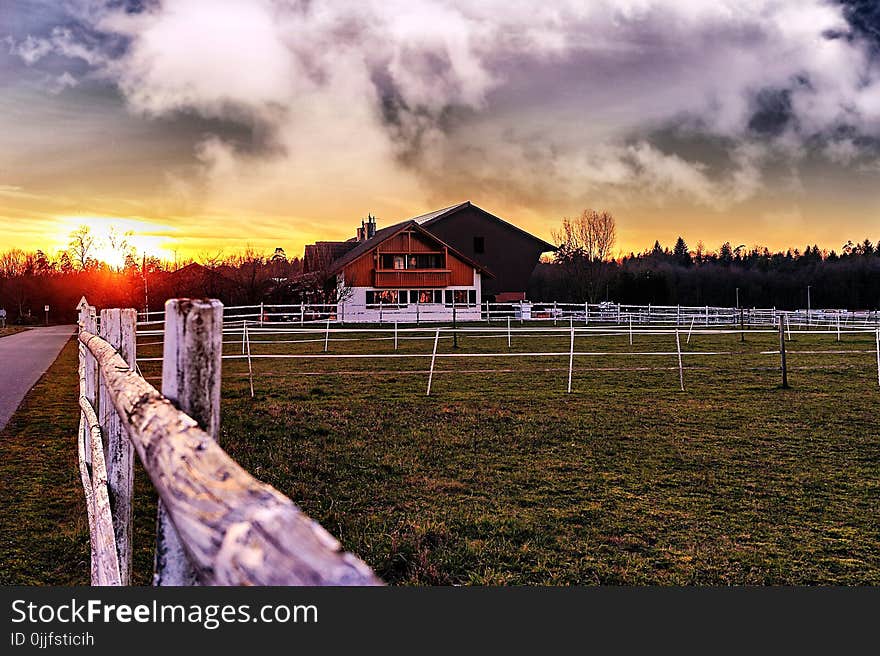 Brown Wooden Barn Under Cloudy Skie S